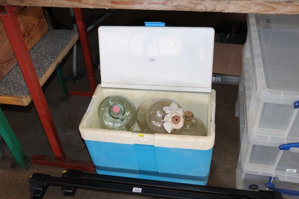 A cooler box and contents of demijohns