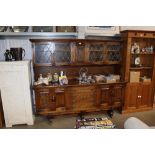 An old charm style dresser fitted four central drawers flanked by cupboards