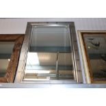 A framed and bevel edge wall mirror