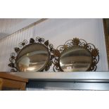 Two circular wrought iron framed wall mirrors