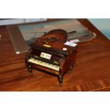 A fruitwood and decorated musical jewellery box in