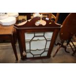 A mahogany and glazed wall mounting corner cabinet