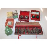 A green resin Buddha; a cased set of worry balls a