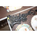 A cast metal door stop with cherub decoration