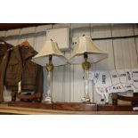 A pair of gilt metal mounted Corinthian column table lamps and shades