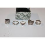 Three silver rings and two dress rings