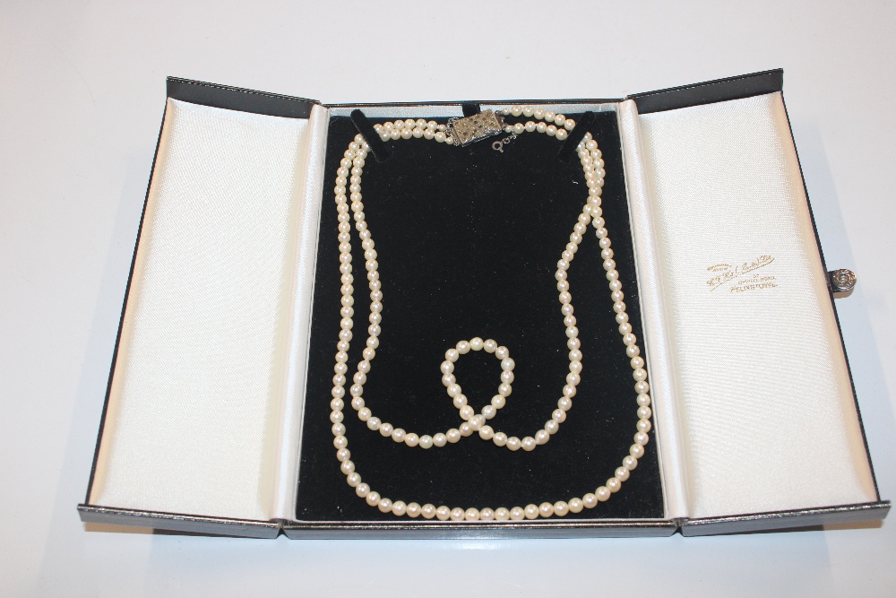 A double string of cultured pearls with silver and