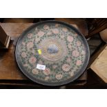 A circular lacquered tray with floral decoration