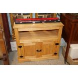 A stripped pine side cupboard