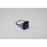 A white metal ring, marked 14K set with blue and w