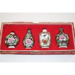 A boxed set of four Chinese snuff bottles in the C