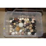 A collection of various hardstone eggs and spheres