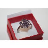 A Sterling silver and amethyst dress ring, size T/