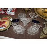 A collection of various cut glass and plated salts
