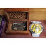 A wooden box containing various keys together with