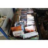 A box containing various CDs and video games