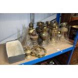 A quantity of various oil lamps, some converted to