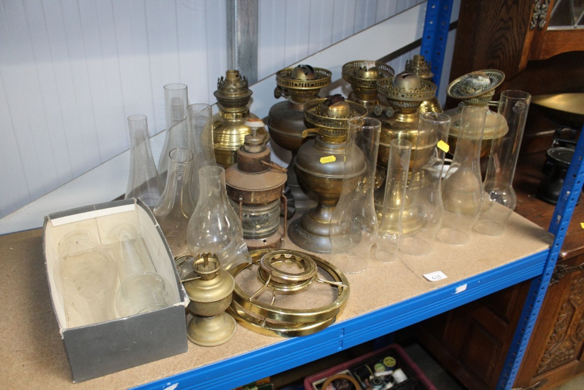 A quantity of various oil lamps, some converted to