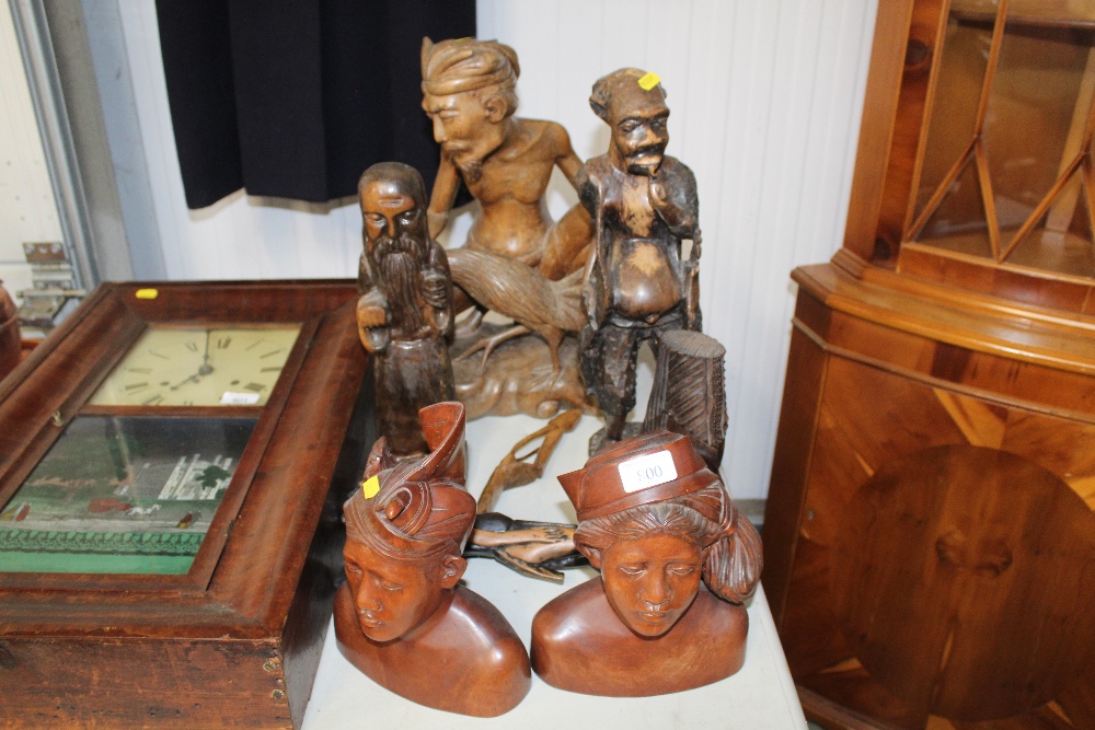 A collection of carved wooden ornaments and busts