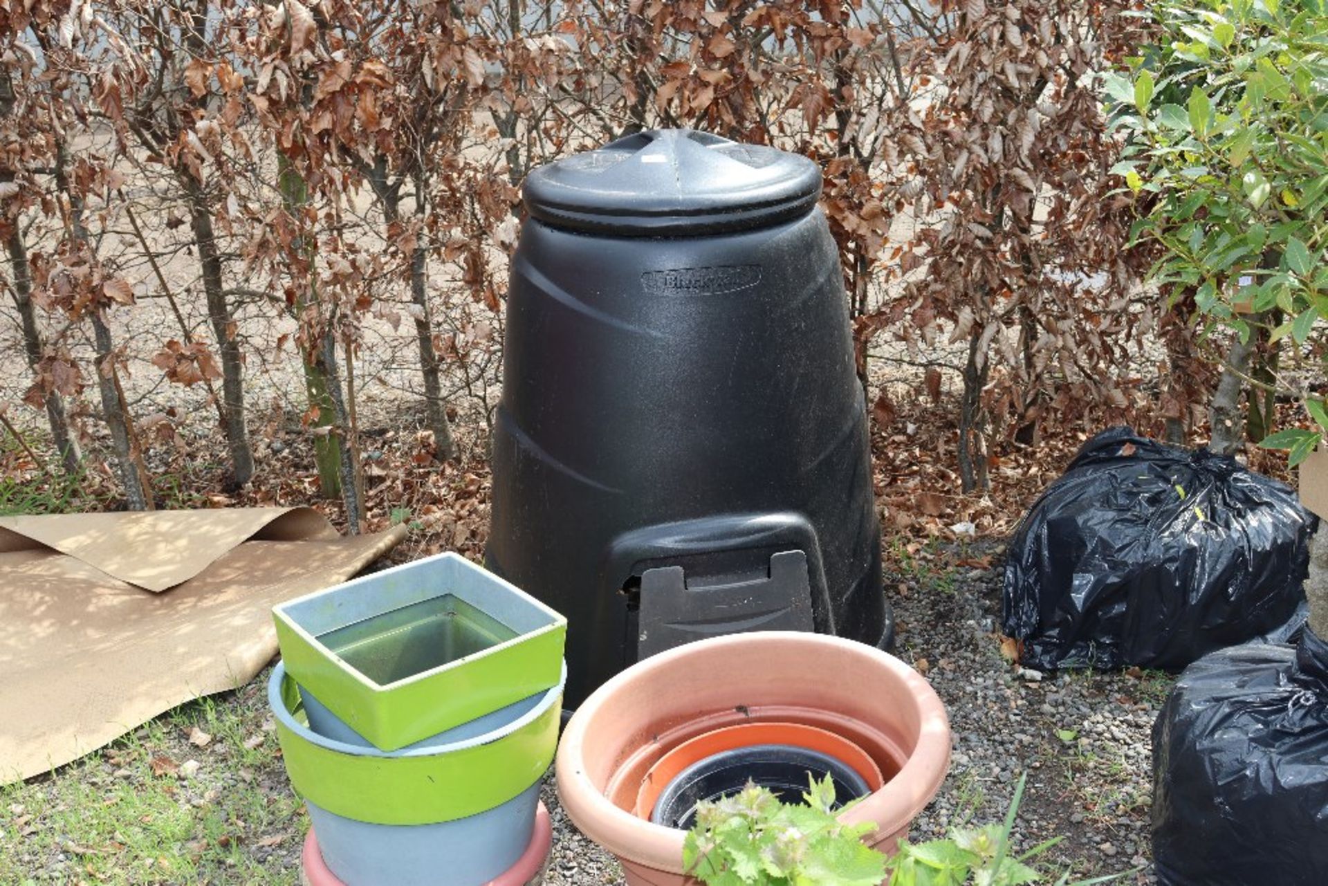 A black wall compost bin