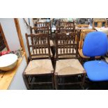 Six oak rush seated and spindle back dining chairs