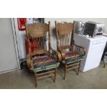 A pair of carved oak spindle back elbow chairs