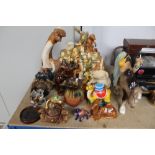 A quantity of various camel ornaments; a wooden pl