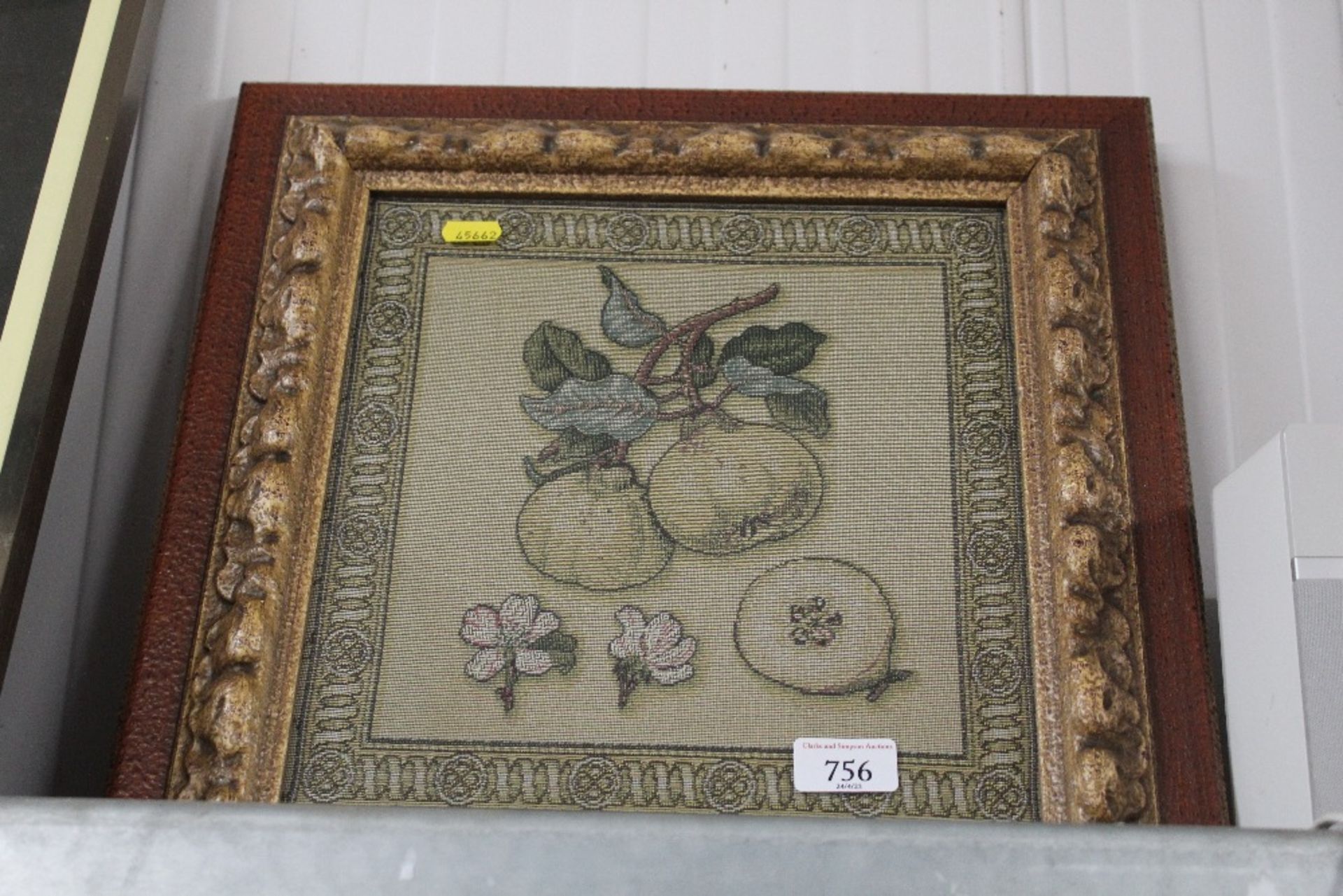 A framed and glazed tapestry depicting fruit