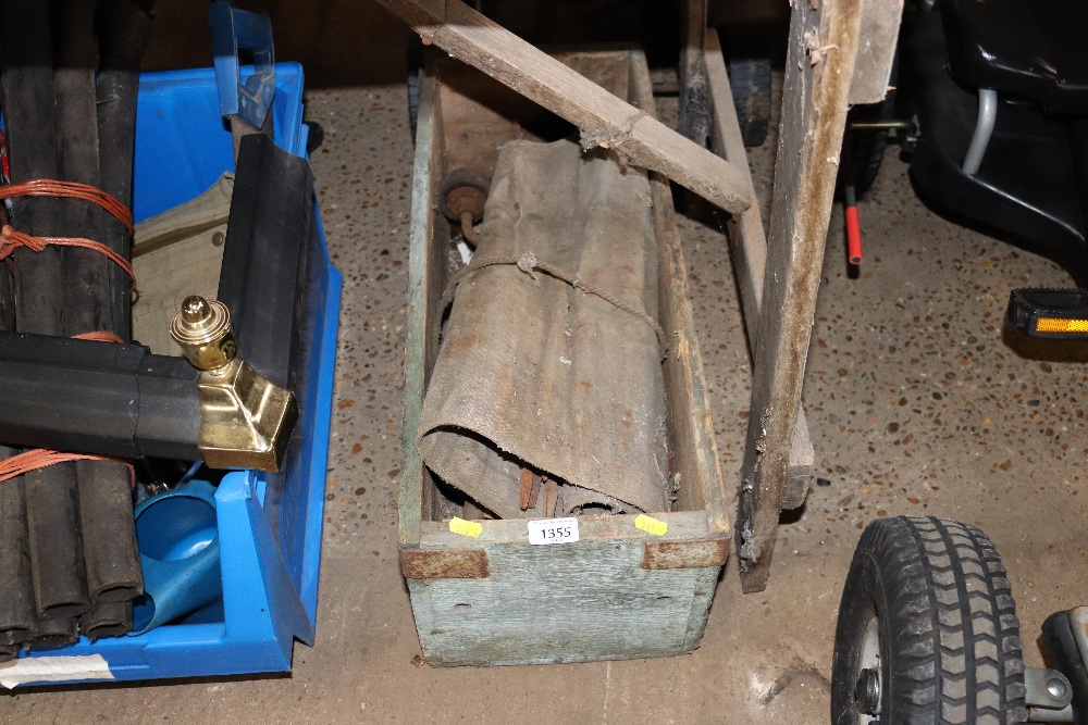 A wooden box of various hand tools