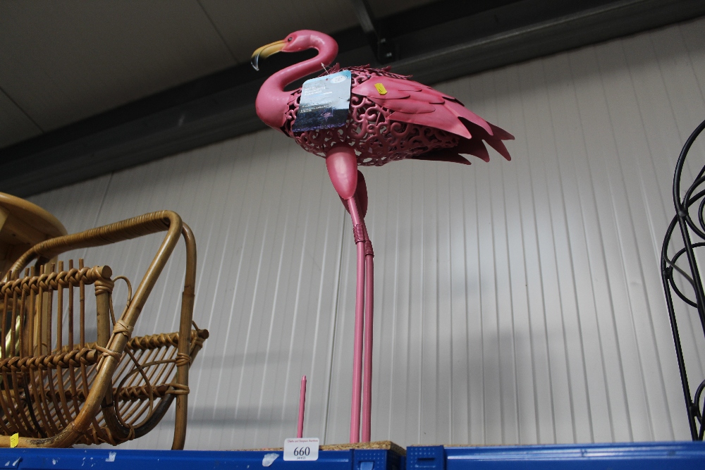 A pink flamingo garden ornament