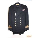 A WWII era Navy uniform jacket with medal ribbons