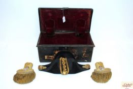 A Naval bicorn hat with a pair of epaulettes and h
