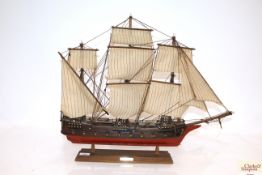 A model ship on display plinth with plaque "Frigat