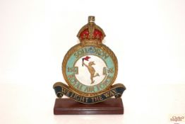 A WWII era cast plaque mounted on wooden plinth. T