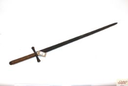 A sword with blade marked with half moon's on both