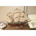 A model ship on display plinth with plaque "Frigat