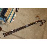 A collection of various vintage walking sticks and