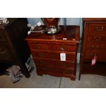 A reproduction mahogany chest of two short and thr