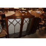 A Regency style mahogany bookcase with scroll arch