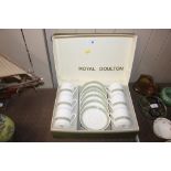 A cased set of six Royal Doulton coffee cups and s