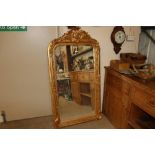 A decorative gilt framed wall mirror