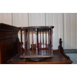 An Edwardian revolving table top bookcase