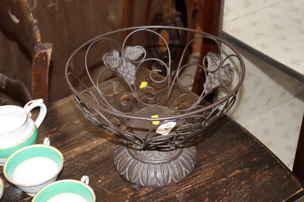A bronzed metalwork fruit bowl with leaf and fruit