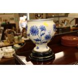 A heavy blue and white floral decorated ceramic ur