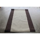 An approx. 6'2" x 4'4" modern patterned rug