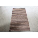 An approx. 4'10" x 2'8" modern rug