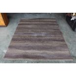 An approx. 7'4" x 5'7" modern rug