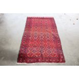 An approx. 6'6" x 3'6" Eastern red patterned rug