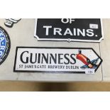 A reproduction cast iron Guinness advertising sign