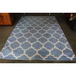 An approx. 9'10" x 6'10" blue and white patterned